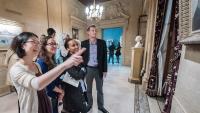 Medical students examine paintings as part of narrative medicine storytelling.